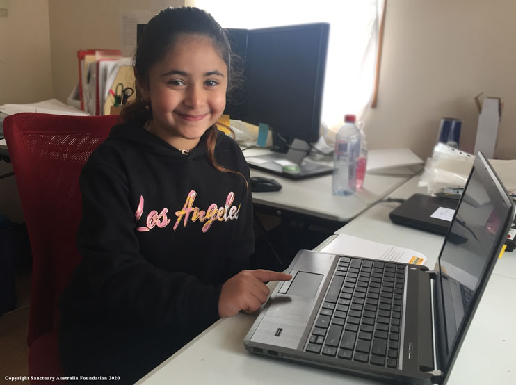 Girl using computer donated by Sanctuary